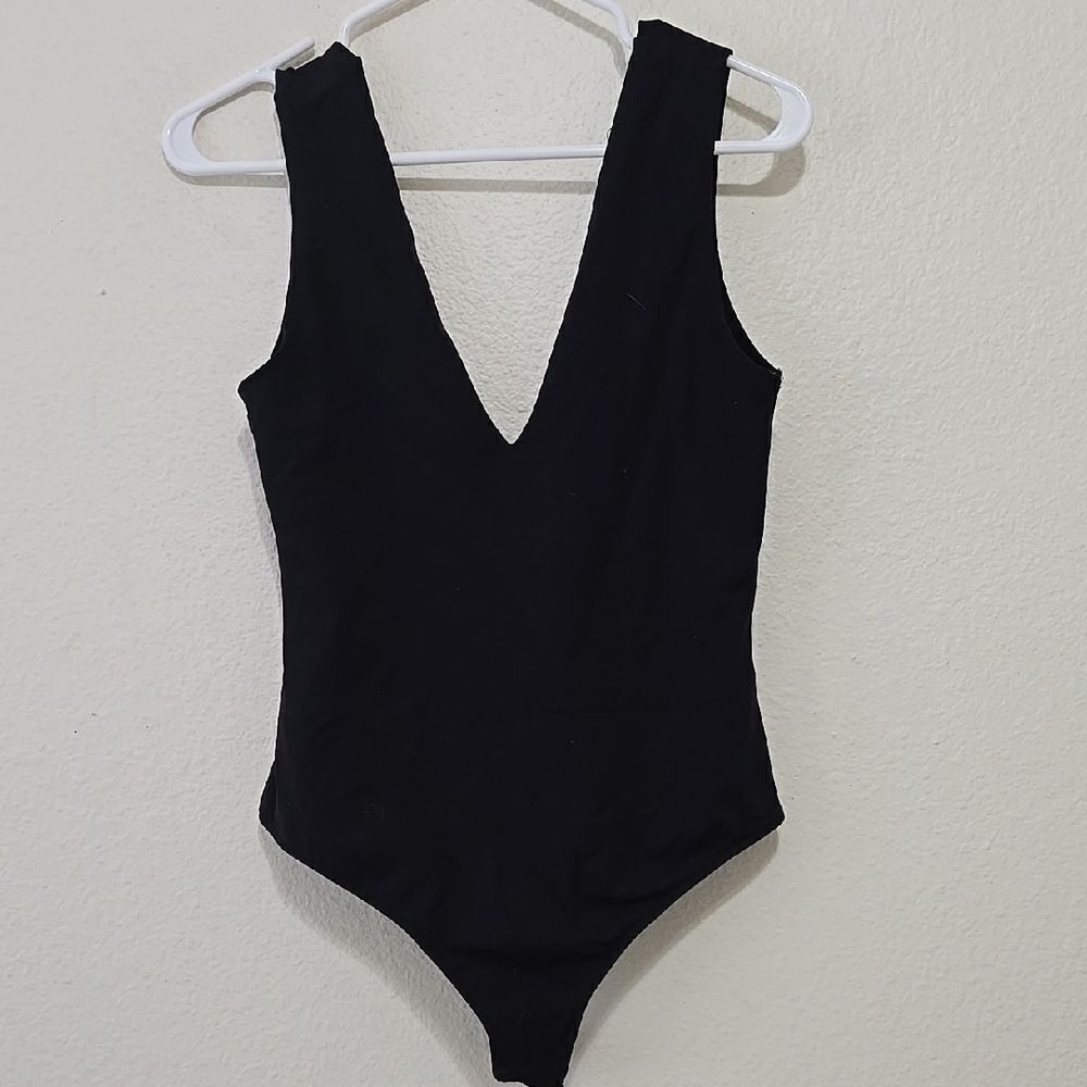 Free People Black Bodysuit with Deep V-Neck and High-Cut Design